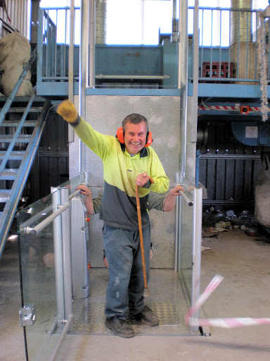 Elevator Boutique service technician working on a home elevator